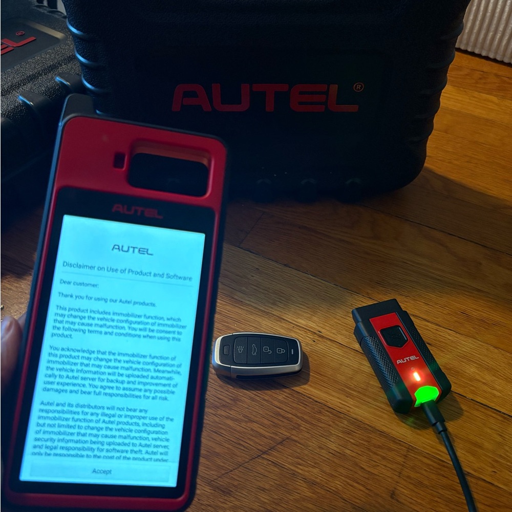 Autel Red and Black Automotive Diagnostic Tool